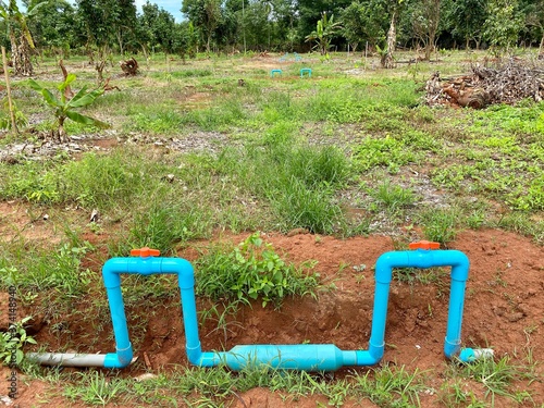 dig the soil to lay the PVC water pipe in garden
