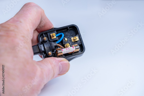 Fotografija Changing the 3 amp fuse and checking the wiring in a UK electrical appliance  pl