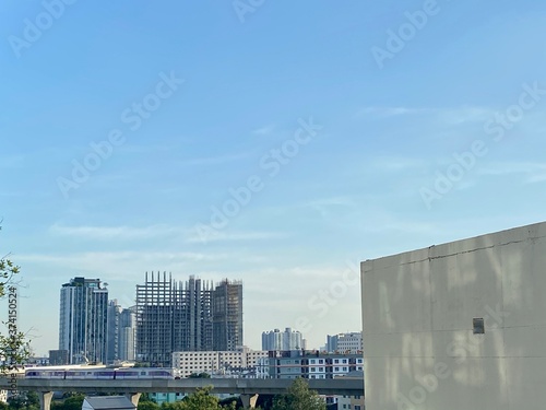 rooftop city view with sky train and building under construction in Thailand