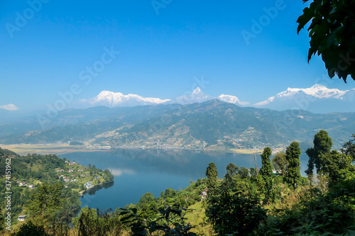 Panoramic view on Phewa Lake from World Peace Pagoda in Pokhara  Nepal. In the back there are high  snow capped Himalayan chains  with Mt Fishtail  Machhapuchhare  between them. Serenity and calmness