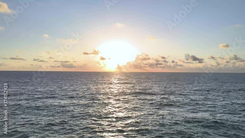 Stunning panoramic 4K view of bay against horizon with sunset and orange sky under dense moving clouds. Time Lapse of landscape of the Blue Sea in Phuket Thailand. Bright sky background.