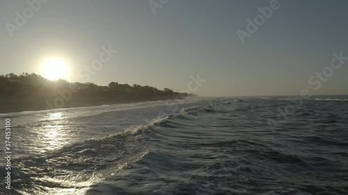 Flying over the waves lapping on the Marbella sand in Spain