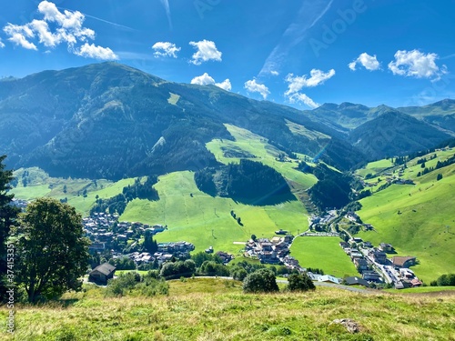 View of Hinterglemm village and mountains in Saalbach-Hinterglemm skiing region in Austria on a beautiful summer day. photo