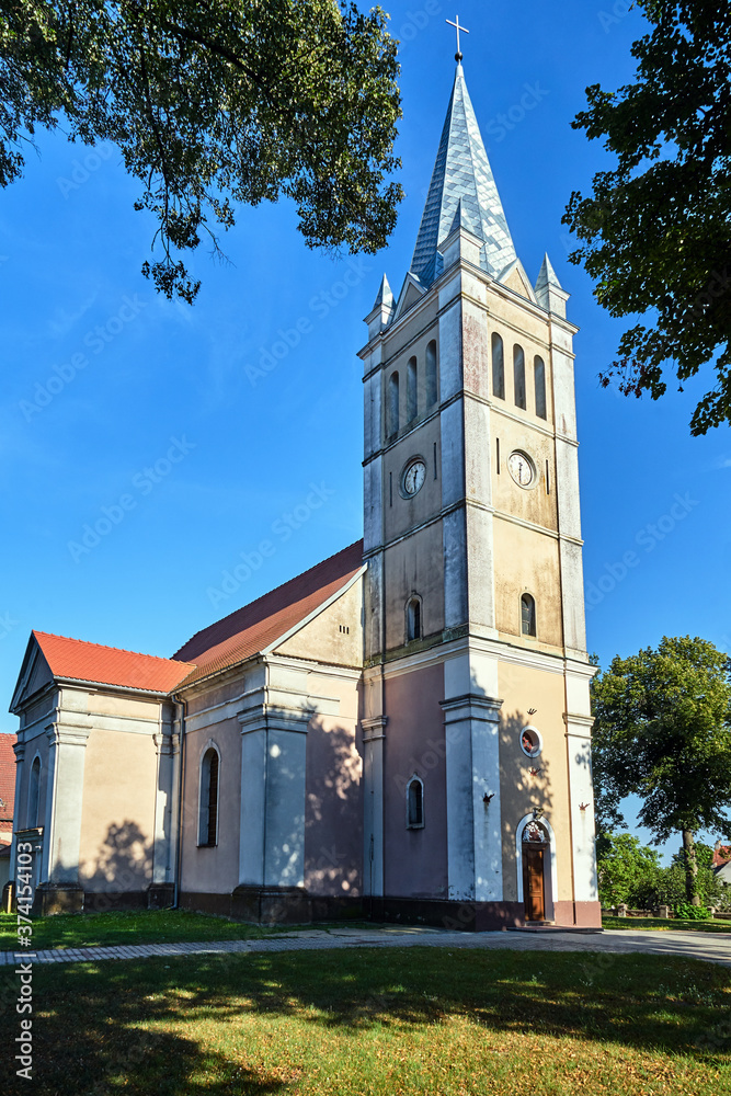 a historic classicist church with a bell tower in the village of Templewo