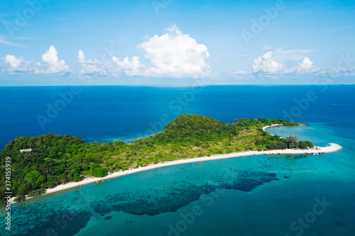 Fototapeta Naklejka Na Ścianę i Meble -  Aerial scenery of picturesque island with crystal azure water and green vegetation.Bird's eye view of paradise beach shoreline, beautiful tourist destination for summer vacations, sport attractions