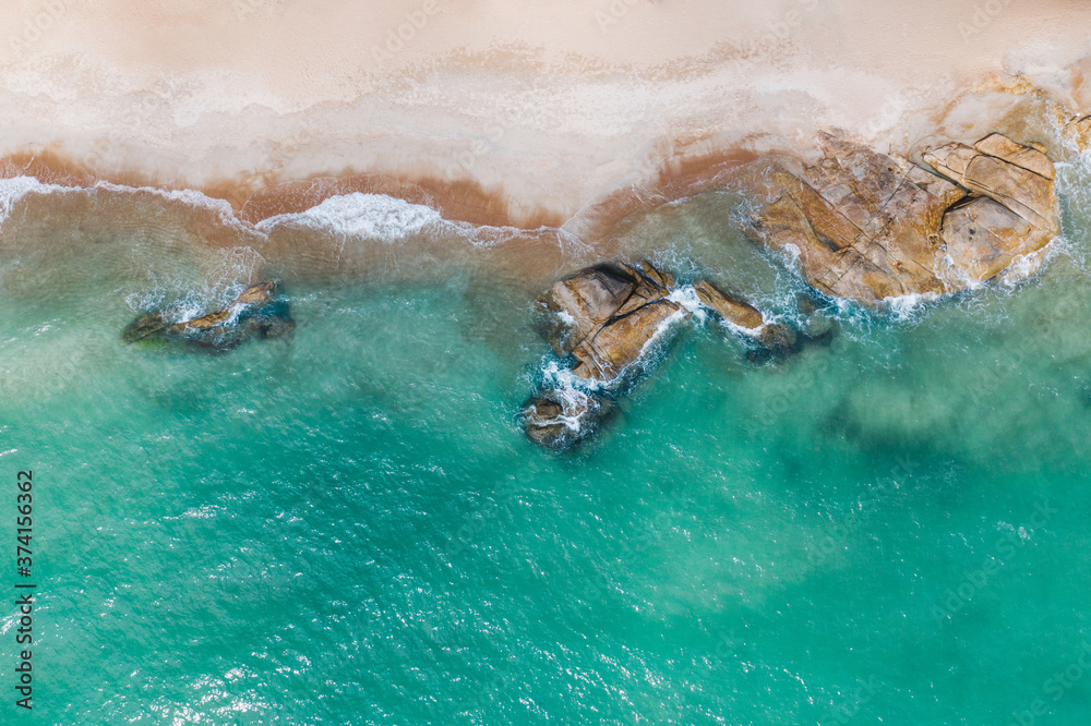 Aerial scenery of picturesque coastline with turquoise crystal water and foam waves. Bird's eye view of paradise beach shoreline of Hawaii, beautiful tourist destination for summer vacations holidays