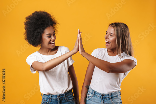 Image of multinational women looking at each other and fist bumping
