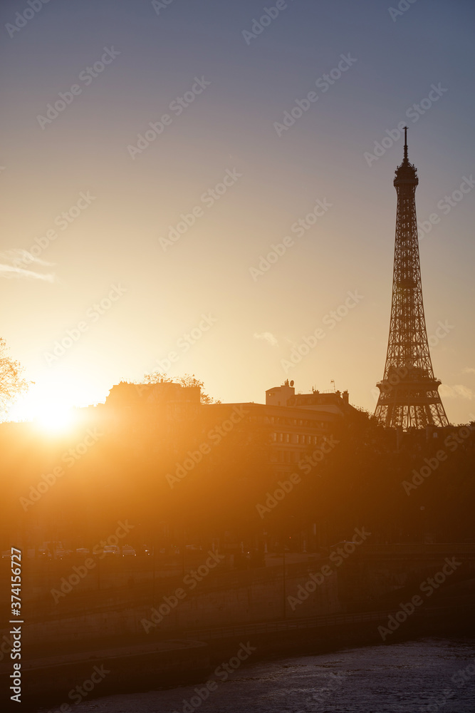 Cityscape of Paris, France and famous landmark Eiffel tower in silhouette just before sunset.