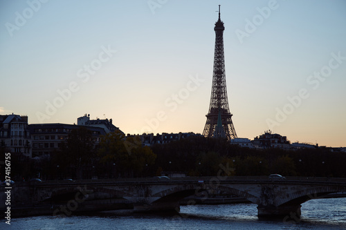 Cityscape of Paris  France and famous landmark Eiffel tower in silhouette just before sunset.