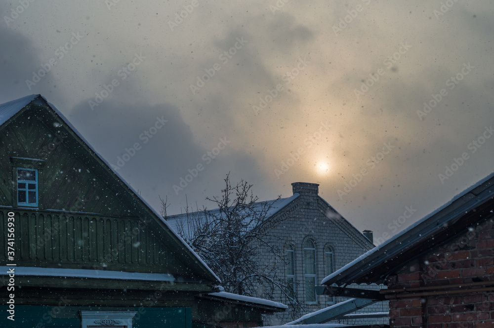 Sun breaks through the clouds, gothic house in the foreground. High quality photo