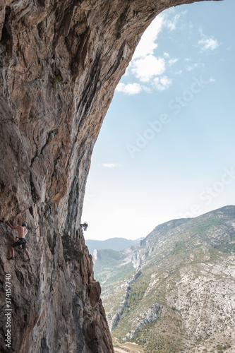 Climbing in a cave with landscape