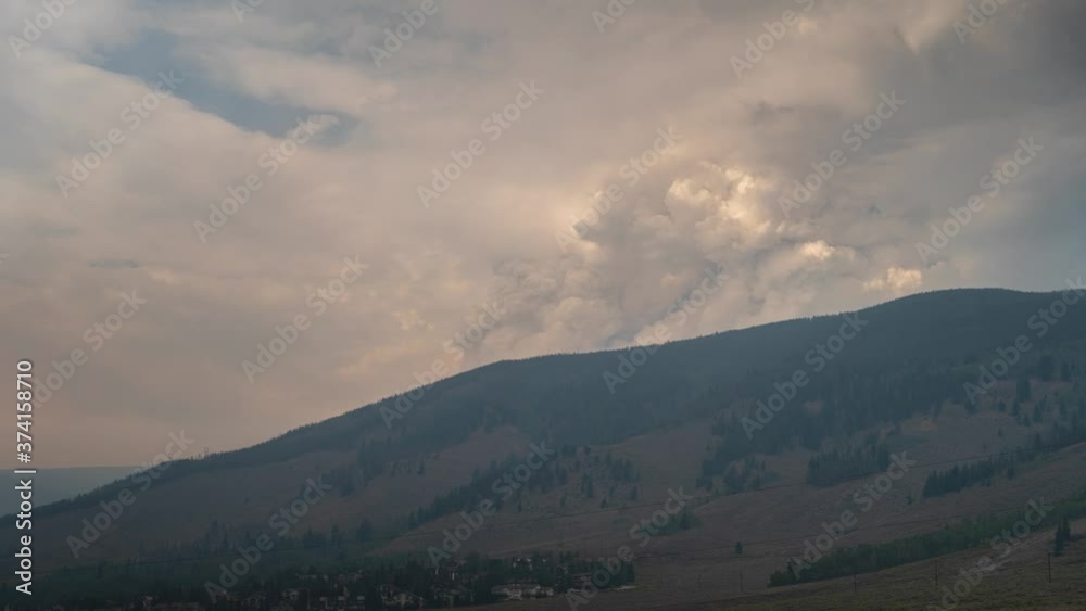 Timelapse of billowing smoke from a wildfire rising over a mountain. Timelapse of billowing smoke from a wildfire rising over a mountain.