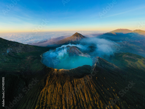 Beautiful aerial landscape photo of a majestic volcanic mountain with blue caldera lake.