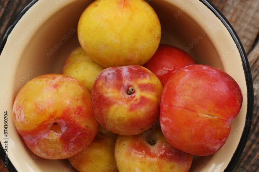 Juicy seasonal plums on the table macro Juicy seasonal plums on the table macro