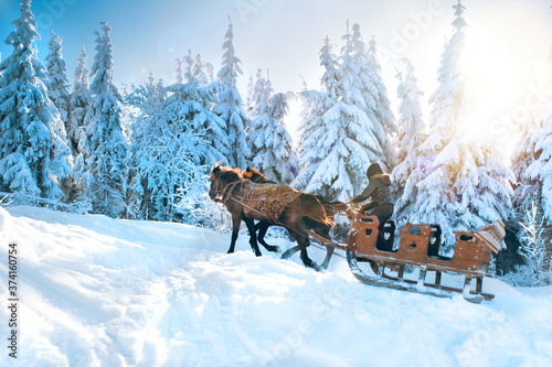 Fotografie Winter landscape with wooden sledges drawn by horses