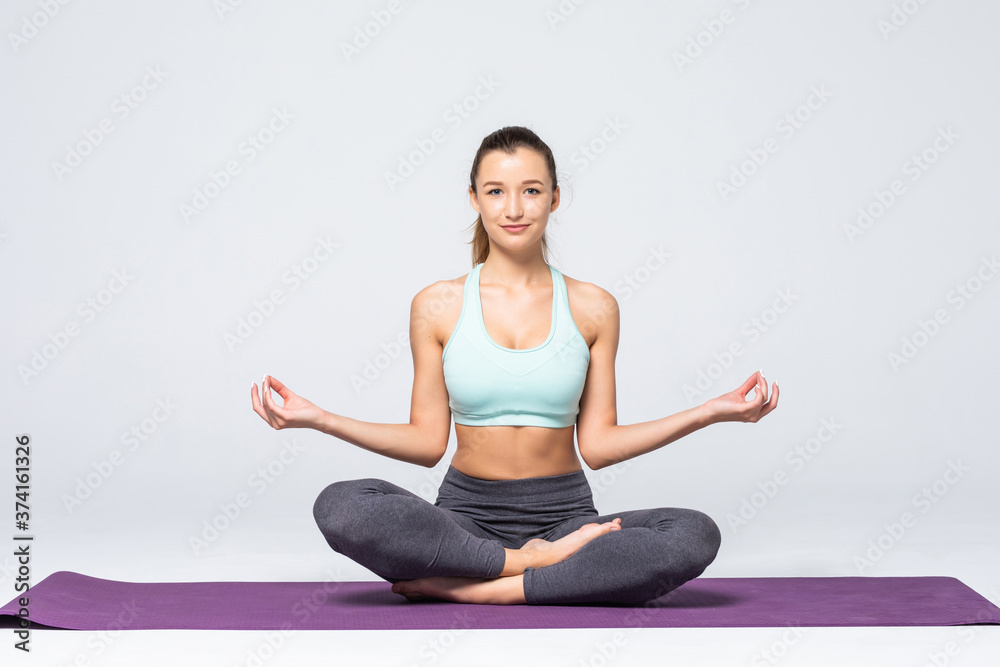 Portrait of young woman meditating in pose of lotus isolated on white background Portrait of young woman meditating in pose of lotus isolated on white background
