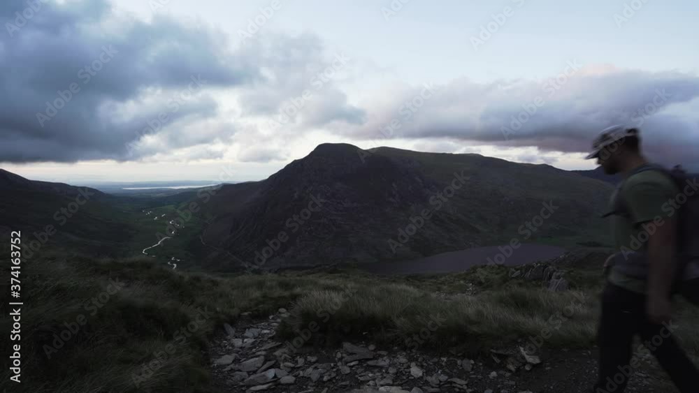 A man walking towards Pen Yr Ole Wen mountain in Snowdonia UK A man walking towards Pen Yr Ole Wen mountain in Snowdonia UK