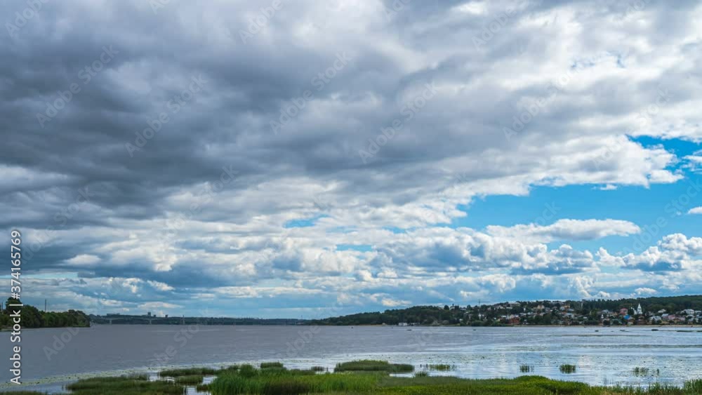 Beautiful summer landscape of the valley with a river. View from the hill. Noon. The wind stirs the grass and branches of trees Beautiful summer landscape of the valley with a river. View from the hill. Noon. The wind stirs the grass and branches of trees