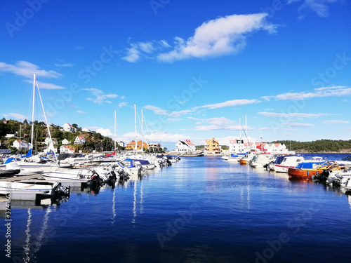 Closeup shot of multicolored boats in the water in Risor, Norway photo