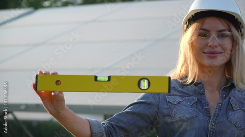 Female enginneer installing new sunny batteries. The future is today photo