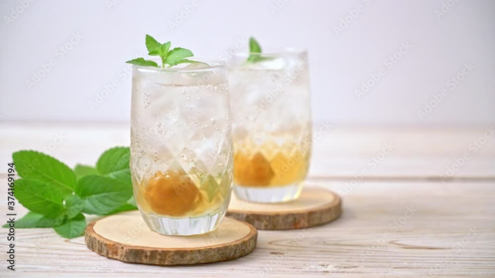 iced plum juice with soda and peppermint on wood table - refreshment drink iced plum juice with soda and peppermint on wood table - refreshment drink