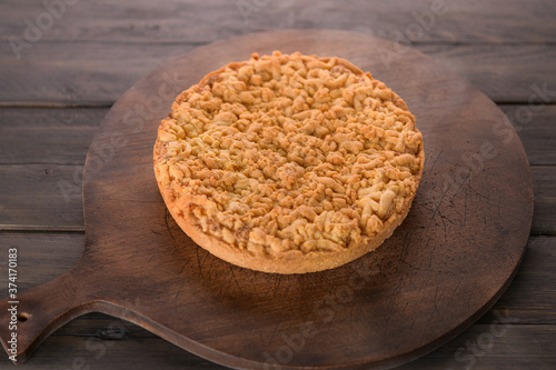 pie with cheese round on a wooden background
