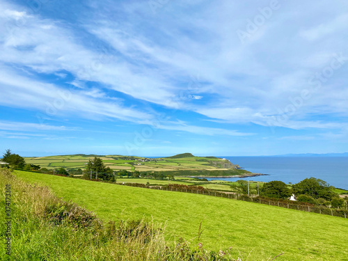 Green fields and coast looking towards the village of Maughold, on the Isle of Man, British Isles