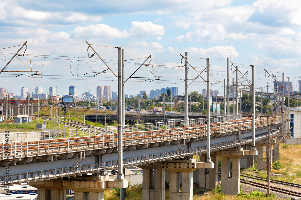 A powerful multi-level railway network with a bend and a flyover against the backdrop of a cityscape. A powerful multi-level railway network with a bend and a flyover against the backdrop of a cityscape.