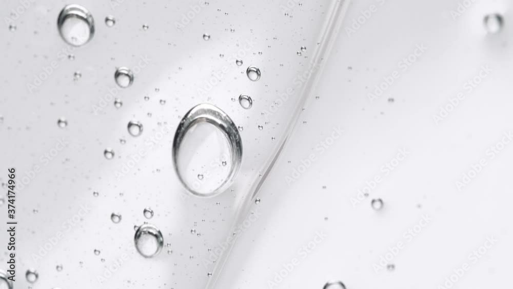 Crystal Clear Gel Cosmetic With  Molecule Bubbles As It Slowly Slides Down. - Macro Shot