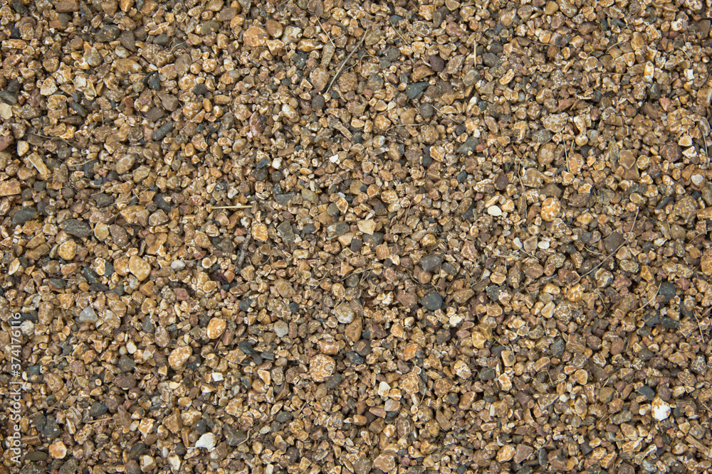 Small stones of seamless texture. Seamless surface texture covered with small dark brown stones. Small stones of seamless texture. Seamless surface texture covered with small dark brown stones.