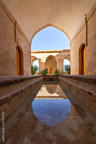 Canvas Print Ancient theological school known as Zinciriye Madrasa and reflection in its shal