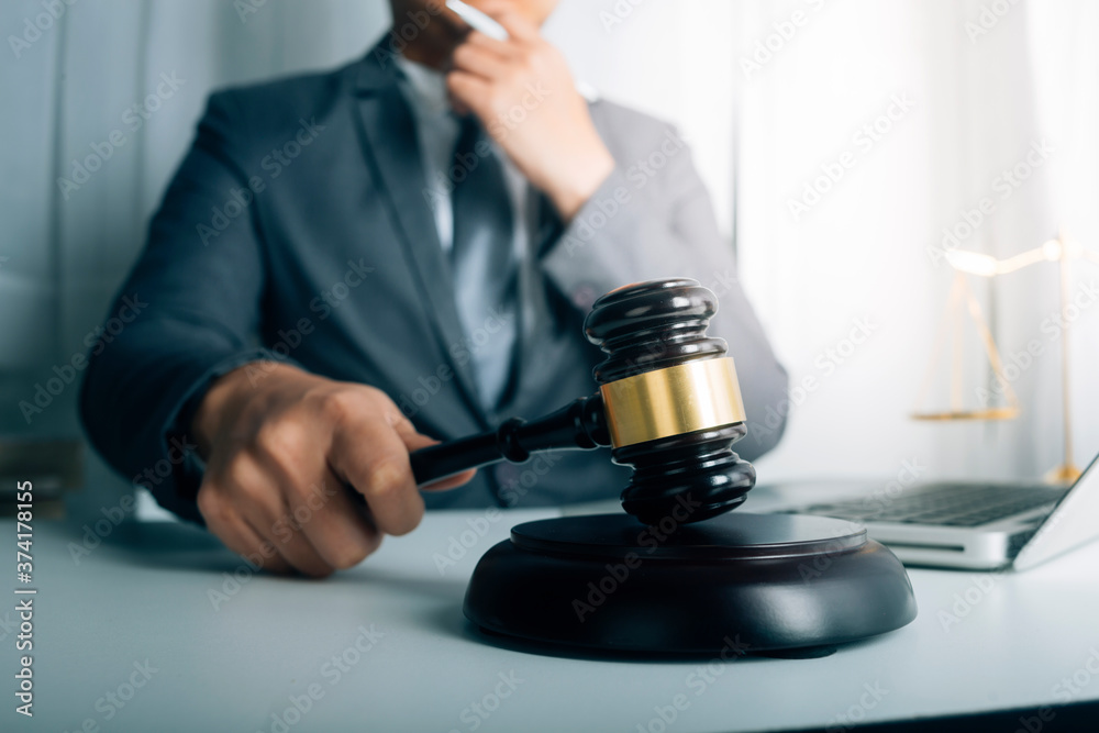Business and lawyers discussing contract papers with brass scale on desk in office. Law, legal services, advice, justice and law concept picture with film grain effect