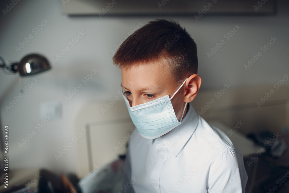 Little boy dressing uniform and medical mask preparation back to school.