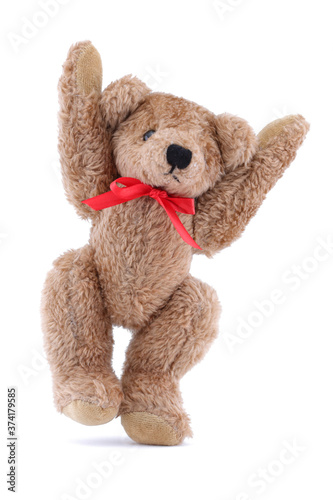 Jumping brown Teddy bear with red ribbon on white background
