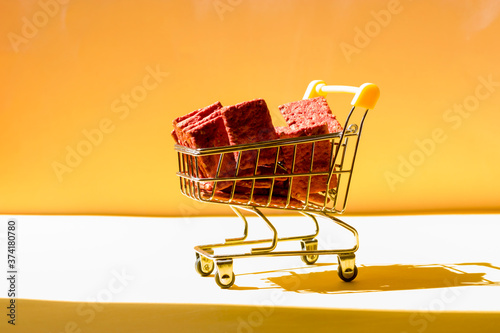 Natural crackers or beetroot cookies in a basket on a yellow background. Healthy food concept for wellness. Diet foods.