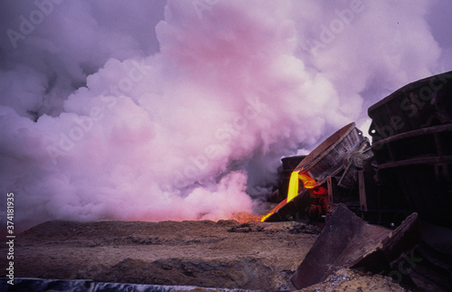 Clouds of steam when cooling a hot metallurgical blast furnace slag to obtain granules necessary for the production of slag cement.