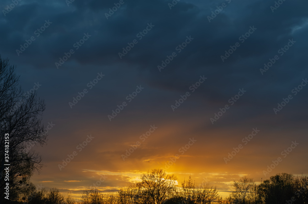 Fototapeta premium Sunset and dark rain clouds.