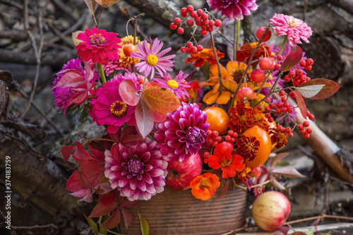 Fototapeta Naklejka Na Ścianę i Meble -  Beautiful red pink yellow orange autumn bouquet with fall flowers and colorful leaves