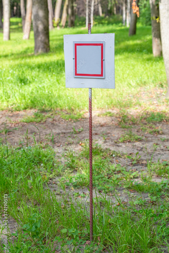 Iron sign without signs and symbols on a green summer lawn Iron sign without signs and symbols on a green summer lawn