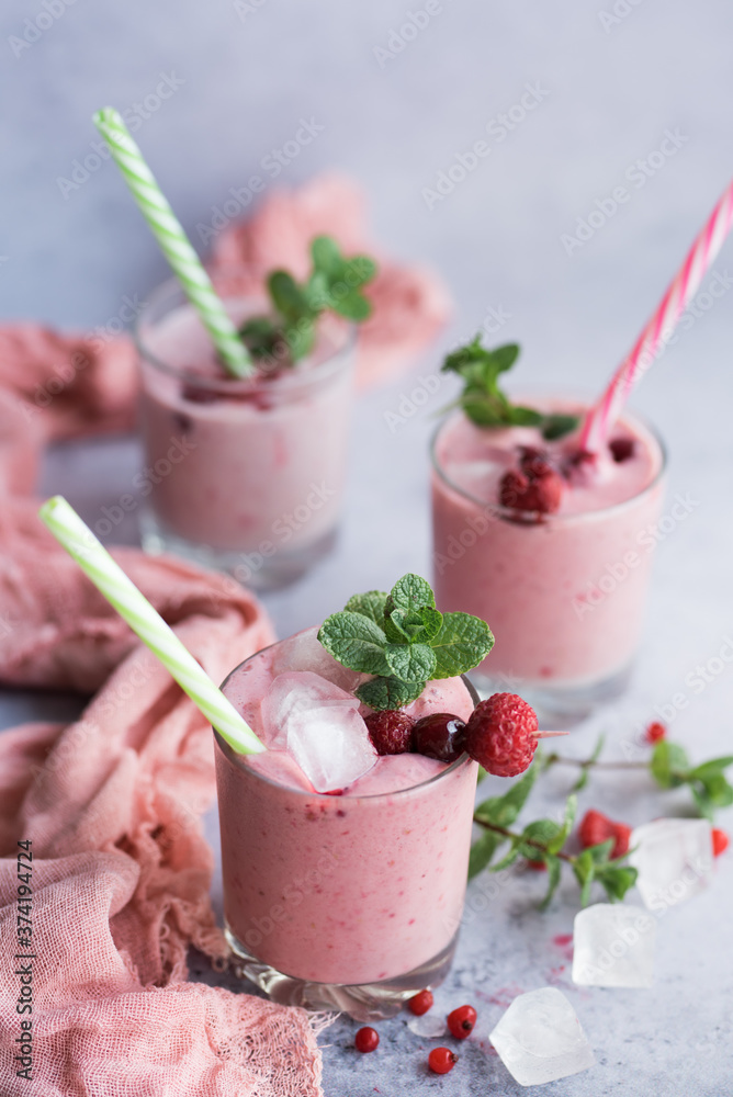 Glasses of berry smoothie on light background. Glasses of berry smoothie on light background.