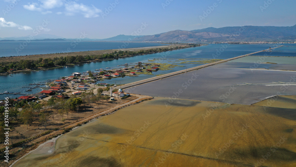 Aerial drone photo of artificial sea salt ponds in area Tourlida of Kleisova lagoon featuring seaside traditional settlement, Mesolongi, Aitoloakarnania, Greece