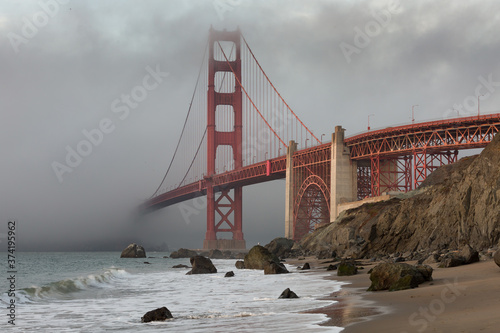 The Golden Gate Bridge in downtown San Fransisco covered in fog, as seen from Marshall's Beach