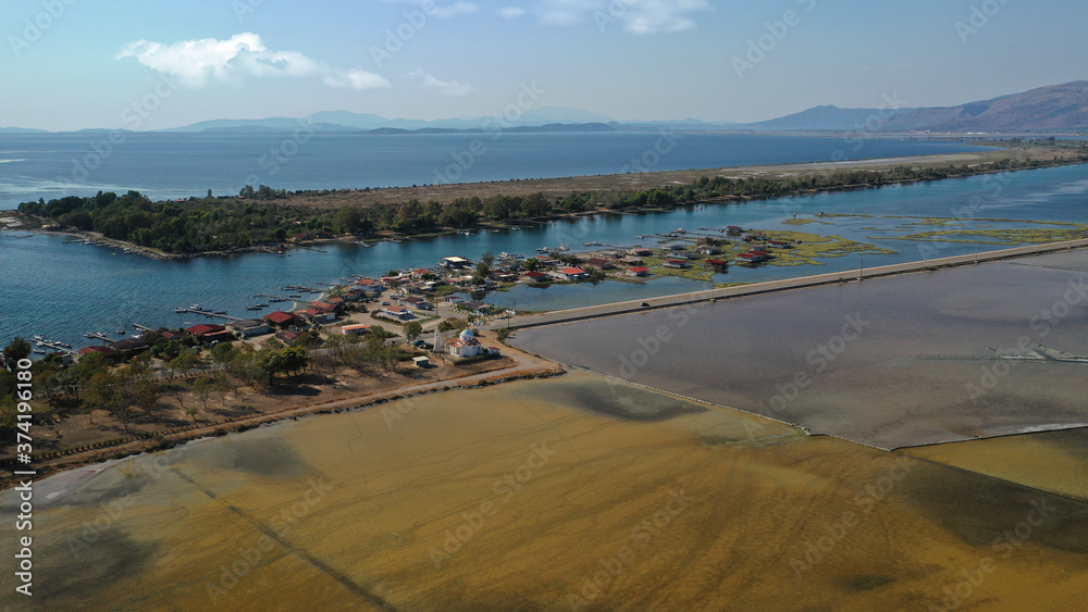 Aerial drone photo of artificial sea salt ponds in area Tourlida of Kleisova lagoon featuring seaside traditional settlement, Mesolongi, Aitoloakarnania, Greece