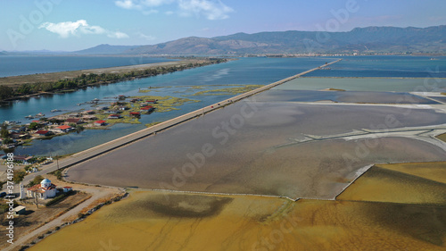 Aerial drone photo of artificial sea salt ponds in area Tourlida of Kleisova lagoon featuring seaside traditional settlement, Mesolongi, Aitoloakarnania, Greece photo