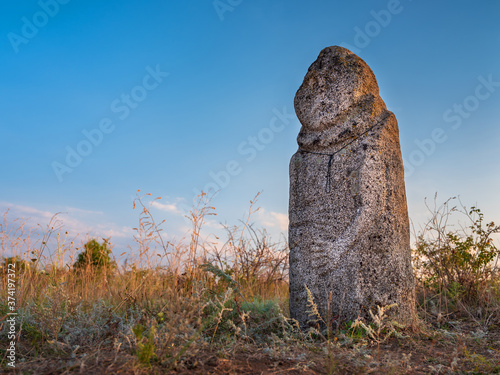 stone prehistoric statue of woman in national park in Ukraine in Europe under blue sky with copy space