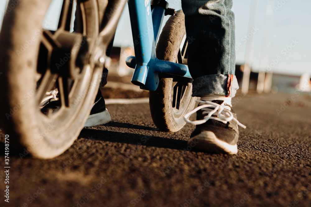 Naklejka premium A boy rides a balancing bike. Active walk