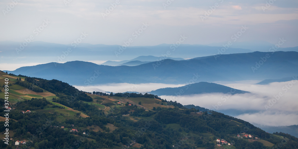 Landscape view on mountains, hills and meadow, village in Tara national park in Serbia