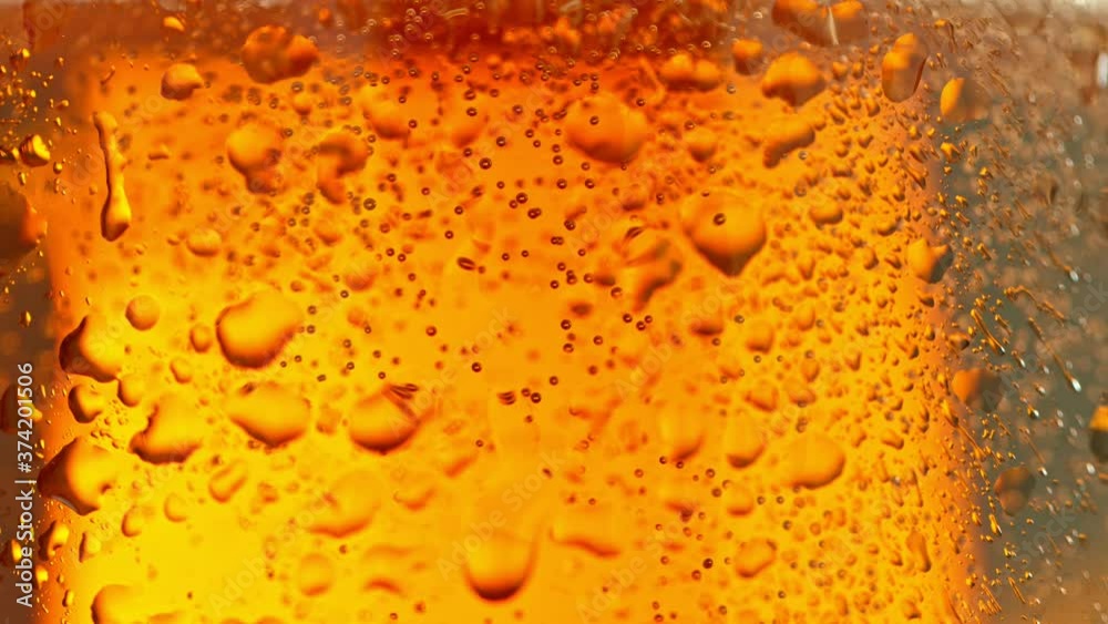 Macro Shot Of Bubbles Rising In A Glass With Beer, Super Slow Motion at 1000 fps. Macro Shot Of Bubbles Rising In A Glass With Beer, Super Slow Motion at 1000 fps.