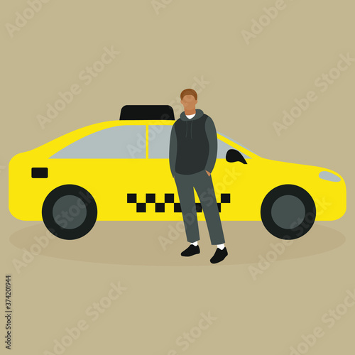 A young man stands near a taxi