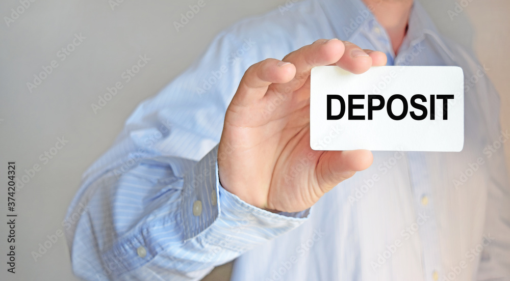 Business man holding a business card. The content of the lettering has implications for business concept and marketing. Business man holding a business card. The content of the lettering has implications for business concept and marketing.